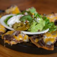 Nachos · 8 wedges topped off with your choice of beef or chicken fajitas, beans and melted cheese ble...
