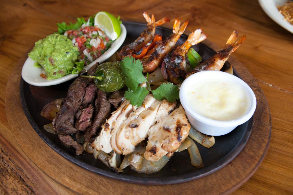 Agave Combo  · 4 of our brochette shrimp with beef and chicken fajitas. Served with pico de gallo and guacamole. 