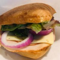 Turkey and Swiss Bagel Sandwich · Turkey and Swiss on a toasted bagel served with our Sprocket Aioli, lettuce, and red onion