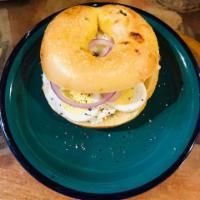 Egg Bagel Sandwich · On a toasted bagel, sliced hard boiled egg, capers, fresh cracked pepper, salt, and red onio...