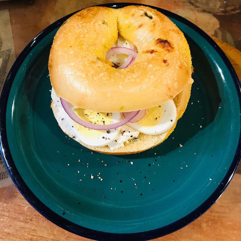 Egg Bagel Sandwich · On a toasted bagel, sliced hard boiled egg, capers, fresh cracked pepper, salt, and red onions. 