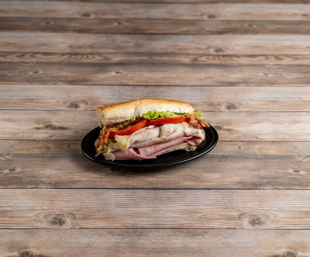 Club · Turkey, Ham, Bacon and Provolone cheese. Toasted and dressed with Lettuce, Onions, Tomatoes, Black Pepper, Oregano, and Oil & Vinegar Dressing.