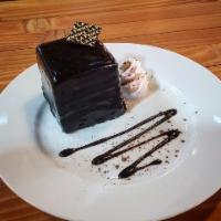 Black Beauty · Chocolate cake brushed with vanilla syrup, layered with dark chocolate ganache, and mousse.
