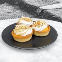 Lemon Tart · Luscious lemon pastry cream and toasted meringue in a tart shell, finished with lemon bark
