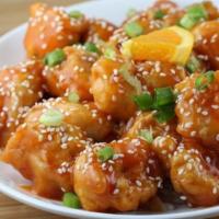 S4. Sesame Chicken · Crispy breaded chicken chunks with sweet brown sauce spread with sesame seeds, served with b...