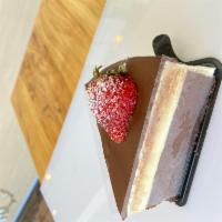 Triple Chocolate Cake · Layers of flourless dark chocolate cake, milk chocolate, and light white chocolate mousse.(G...