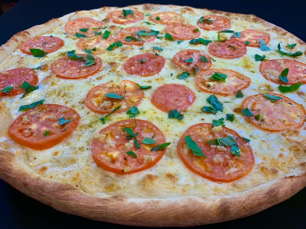 Tomatoes and Basil Pizza · Sliced tomatoes, olive oil, mozzarella, fresh basil and garlic.