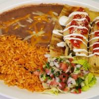 Chicken Tamale Plate · 2 tamales come topped with tomato sauce and sour cream. Also comes with rice, refried beans,...