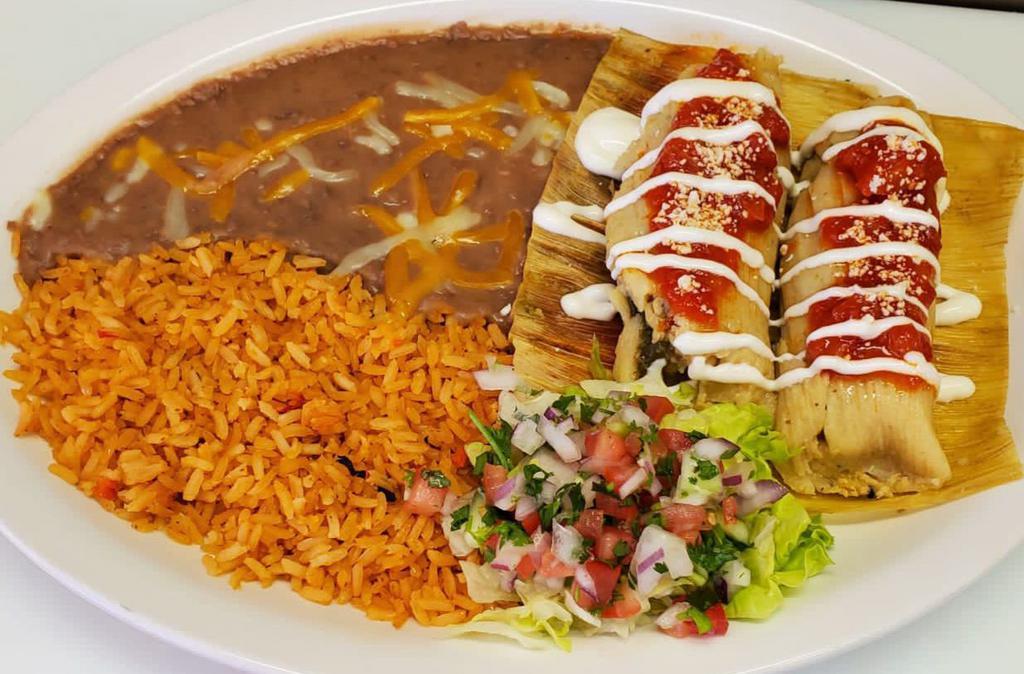 Chicken Tamale Plate · 2 tamales come topped with tomato sauce and sour cream. Also comes with rice, refried beans, lettuce, and pico de gallo. 
