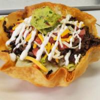 Vegetarian Taco salad (also available with meat under main dishes) · Large round shell filled with beans, rice, lettuce, diced tomatoes, shredded cheese, sour cr...