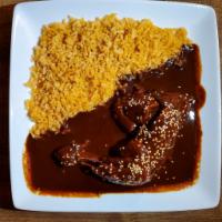 Mole con pollo  · Half of a chicken with mole sauce on top. Comes with rice on the side.