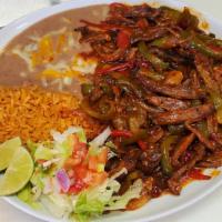 Steak or Chicken Ranchera · Comes with sliced steak, bell pepper, onion, smothered in ranchera sauce. Rice, refried pint...