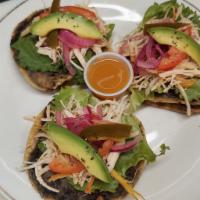 1 Panucho · Homemade tortilla filled with black refried bean and topped with lettuce, cabbage, tomatoe, ...