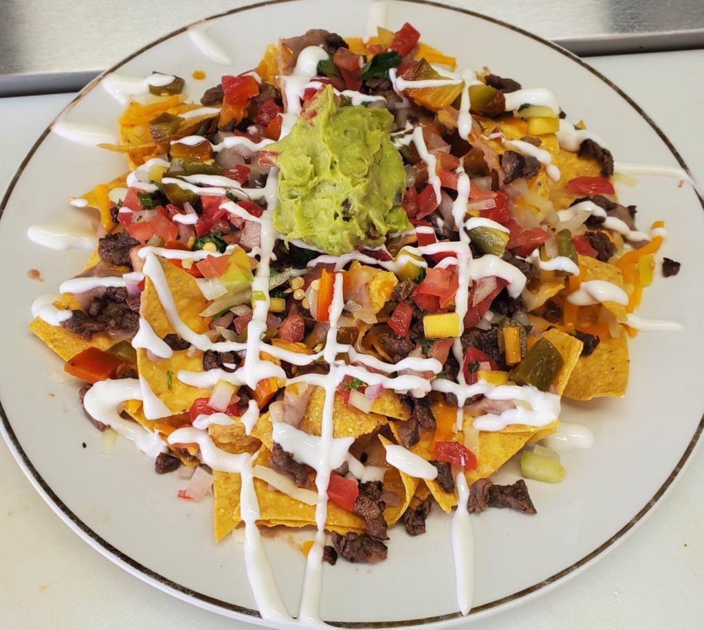 Nachos  · Homemade tortilla chips topped with nacho cheese, pico de gallo, sour cream, guacamole, jalapeños, and your choice of meat. 