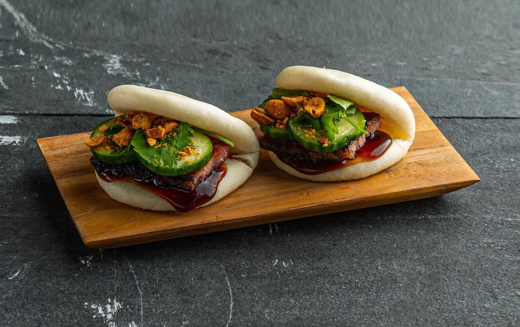 Classic Pork Belly Bao Bun . · Steamed bao buns (2 pcs) with house cured pork belly, hoisin, cucumber, plum sauce, and nuts.
Contains: Peanuts, Gluten, Soy, Fish