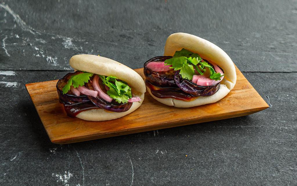 Eggplant Bao Bun . · Steamed bao buns (2 pcs) with eggplant, eggplant sauce, pickled red onion, and cilantro.
Contains: Gluten, Soy, Shellfish