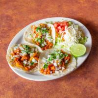 31b. Tacos al Pastor Specialty · 3 tortillas stuffed with seasoned pork, onions, and cilantro.