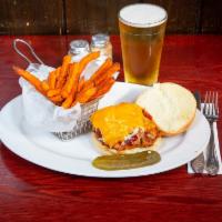 Pulled Pork Sandwich · House smoked pulled pork piled high on a brioche bun and topped with coleslaw and cheddar ch...