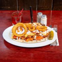 The Wolverine Sandwich · Try it, if you dare! A 9-inch wedge topped with buffalo chicken, BBQ pulled pork, bacon, oni...