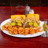 Sloppy Cowboy Sandwich · BBQ smothered shaved rib-eye on a wedge with cheddar cheese, frizzled onions and pickle chips.