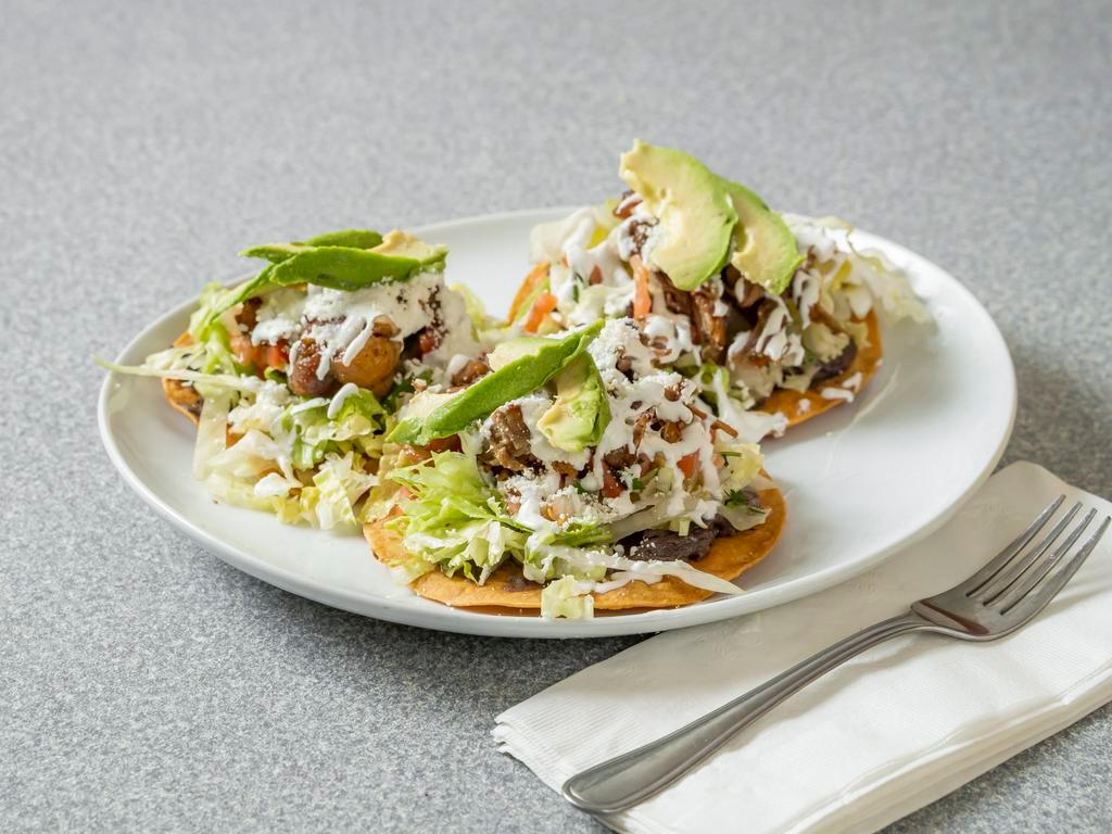 Tostadas  · 3 fried tostadas topped chicken, refried beans, lettuce, tomato, choice of meat, Cotija cheese, and avocado.