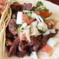 Steak Taco · Taco Platter comes with (3) Tacos topped with Onions and Cilantro, and Rice and Beans. 