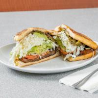 Carnitas Torta · Mexican Sandwich with Roast pork, Bean Spread, Cheese, Lettuce, Jalapeno, Tomato, Avocado.  