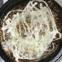 Enchiladas de Mole Platillo · Served with Mexican rice, black beans and corn tortilla.