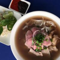 PH1. Pho Xe Lua · Combo with raw beef, brisket, tendons and omosa. Served with flat rice noodle, onion, scalli...
