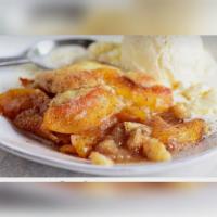 Peach Cobbler Cake Slice · Try our delicious peach cobbler.  It is a soft vanilla cake topped with fresh peaches and cr...