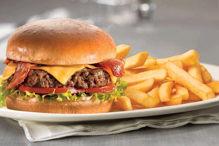 Burger Basket · 8 OZ SEASONED BEEF PATTY WITH CHEESE, LETTUCE, TOMATOES, PICKLES AND ONIONS ON A SOFT BUTTERED BUN  (WITH FRIES)
