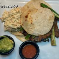 Churrasco · 3 tortillas, grilled steak, coleslaw, red sauce, with grilled onions and guacamole.