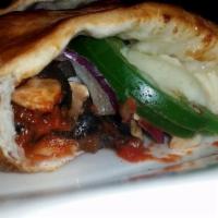 Vegetariano Calzone · Mushrooms, red onions, green peppers, and black olives. Vegetarian.