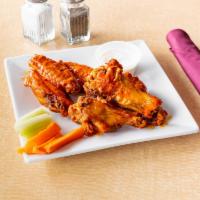 Bone-In Chicken Wings · 6 pieces. Comes with a choice of sauce 
