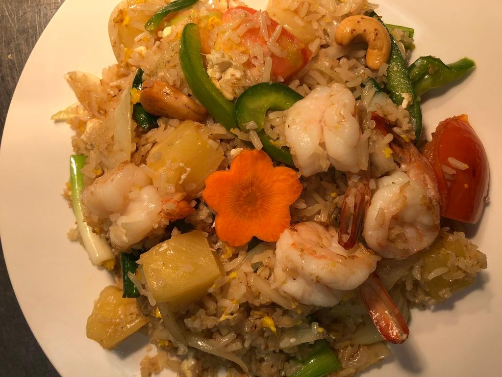 42. Pineapple Fried Rice · Fried rice with choice of meat, pineapple, onion, bell pepper, cashew nut, egg.