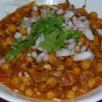Chole Chaat · Chickpea curry, Fresh Cut Tomato & Onion, topped with Tamarind & Cilantro Chutney, crumbled ...