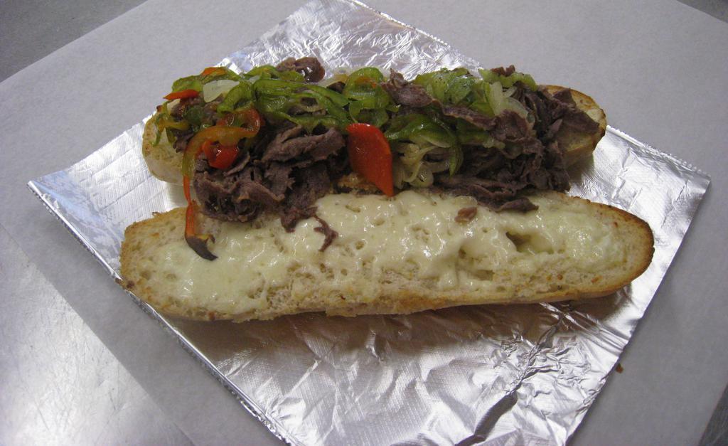 Steak Sub · Tender shaved ribeye steak on a toasted roll with mozzarella with choice of sauce.