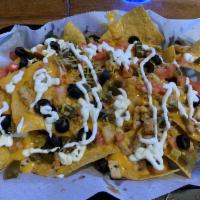 Chicken Nachos · Homemade tortilla chips topped with your choice of pull pork or grilled chicken, nacho chees...