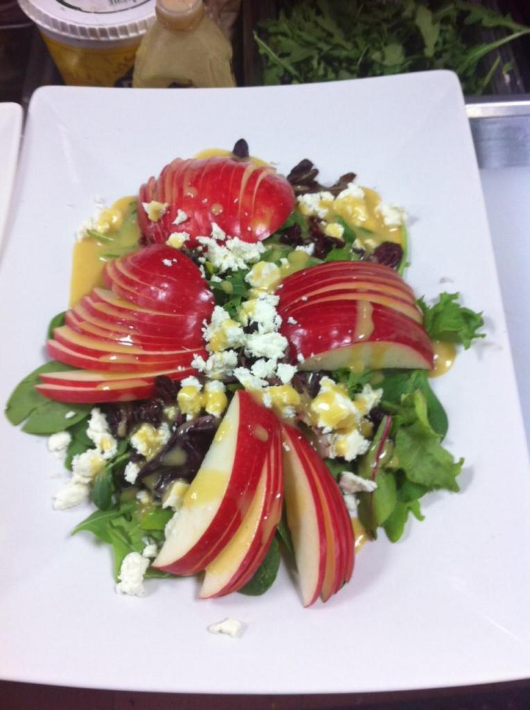 Bella's Salad · Apple, assorted baby greens, ricotta salata and dry cranberries with an apple cider vinaigrette.