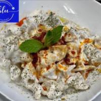 Turkish Dumpling-Manti  · Filled with ground beef and herbs topped with garlic yogurt butter sauce. 