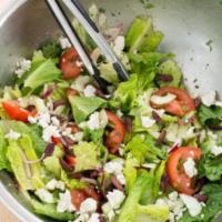 Greek Salad  · Yunan salatasi. Romaine, mesclun, tomatoes, cucumbers, onions, dressed with olive oil and le...