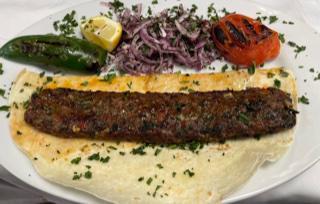 Adana Lamb Kebab  ·  Skewered and grilled ground lamb and flavored with red bell peppers lightly seasoned with paprika served with house salad and rice 