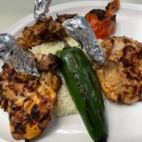 Chicken Chops  ·  Marinated chicken thigh grilled on the bone served with house salad and rice 