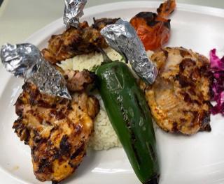 Chicken Chops  ·  Marinated chicken thigh grilled on the bone served with house salad and rice 