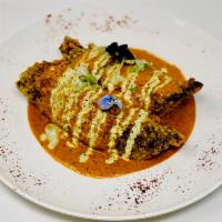 Chiles Rellenos · Chiles rellenos a poblano stuffed with a picadillo consisting of beef, raisins, onions, appl...