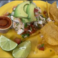 Tostada de Camaron · Marinated shrimp in lime juice. Served on top of a corn fried tortilla with pico de gallo an...