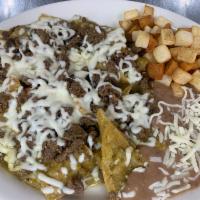 Chilaquiles Beef Plate · Chips soaked in green o house salsa and cheese. Served with potatoes and beans.