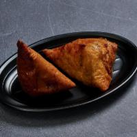 Vegetable Samosa · Potatoes and peas stuffed in a savory pastry. 