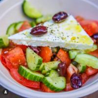 Greek Salad · Tomatoes, onions, olives, feta cheese, olive oil, oregano & capers.