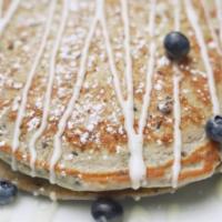 Bangin’ Blueberry Pancakes · 2 decadent Blueberry pancakes topped with powder sugar and butter served with maple syrup